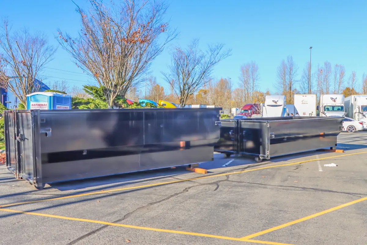 Professional dumpster rental service with roll-off container on residential driveway in Centreville